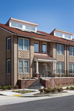 The building is clad in dark red, light red and dark brown brick to create an exterior that gives character to and energizes the façade.