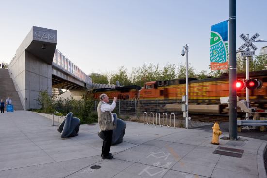 View of the Olympic Sculpture Park from Broad Street showing freight train, bridge, and Louise Bourgeois’s 'Eye Benches' (1996–1997)