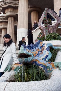 The tile-covered dragon or salamander at the entrance of Güell Park presents a popular photo opportunity for tourists.