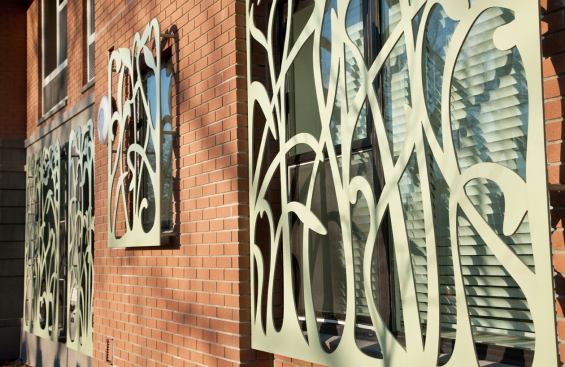 The decorative metal screens on the building were designed by artist Beatrice Coron.