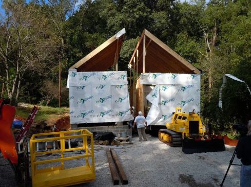 Two modular shells built at Clayton Homes' factory were delivered and joined on-site; roof sections hinged for transport were raised and married on-site.