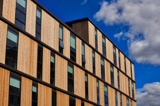 Vertical western red cedar clads the three- to six-story building, designed by Lorcan O'Herlihy Architects.