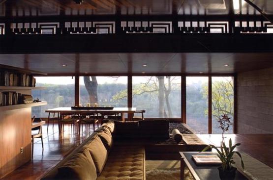 Here, the living and dining room areas are seen at dawn. The kitchen received new high-end cabinetry and concrete countertops.