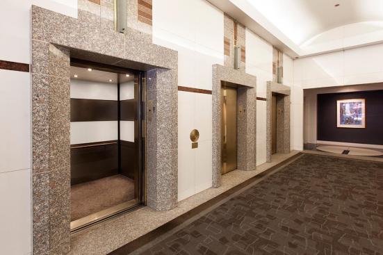 LEVELe-104 Elevator Interior with main panels in ViviChrome Chromis glass, White interlayer, Opalex finish; upper accent and handrail panels in Fused Nickel Silver, Sandstone finish; lower accent panels in Fused Nickel Silver, Sandstone finish, Dallas Impression pattern at 1000 Broadway, Portland, Oregon