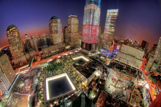 An aerial view of the World Trade Center site. The National September 11 Memorial & Museum are in the foreground and One World Trade Center and Seven World Trade Center are to the right.