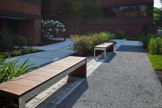 Duo Bench shown with Polished Stainless Steel frame and FSC 100% Jatoba hardwood slats and end at 80 Williams Street, Wellesley, Massachusetts
