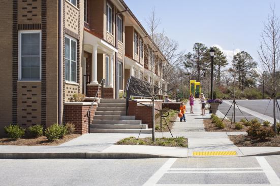 While resident parking is located on either side of the building, the front is designed with parallel parking for guests, activating the neighborhood streetscape.