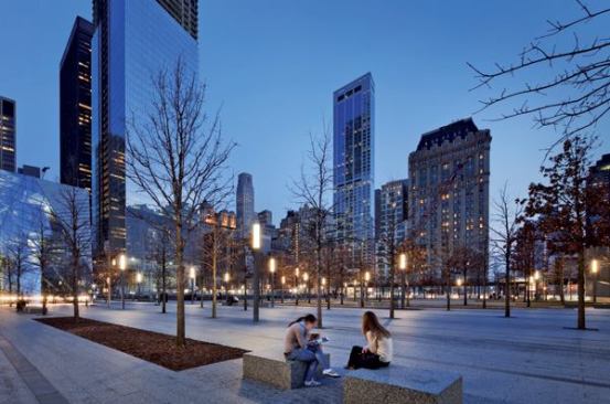 The landscape design includes more than 400 white oak trees across the site. Square light columns, each standing just over 16 feet tall, incorporate security cameras and radio antennas along with the lighting element at the top: prismatic refractors with four 4-foot-long T8 lamps.