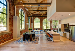 The community room at Yarn Works Apartments features 17-foot windows and 20-foot ceilings.