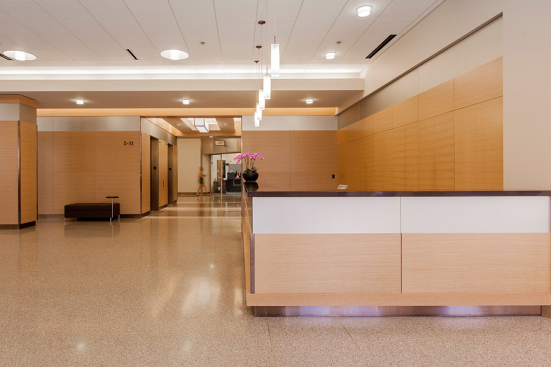 Reception desk, wall accents and elevator transoms in ViviChrome Chromis glass with Taupe interlayer and Opalex finish at Lloyd Center Tower, Portland, Oregon