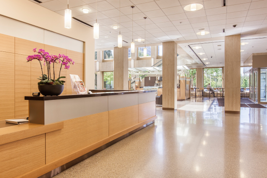 Reception desk and wall accents in ViviChrome Chromis glass with Taupe interlayer and Opalex finish at Lloyd Center Tower, Portland, Oregon