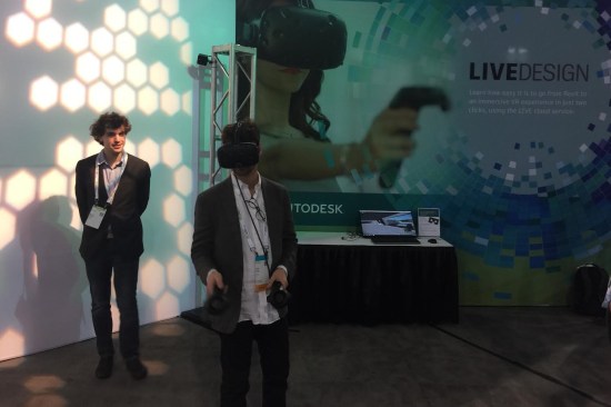 A convention attendee tries out Autodesk Live Design, which creates interactive presentations from Revit models.