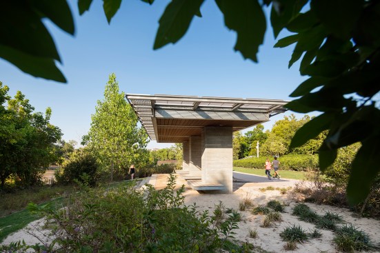 Receding floodwaters left a layer of silt on the landscape and shade pavilions. Some can be reabsorbed into the landscape; the rest is cleared either with shovels or hoses. But the landscape and structures were designed to withstand inundation.