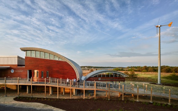 Two 70-foot-tall wind turbines produce nearly half of the building's energy.