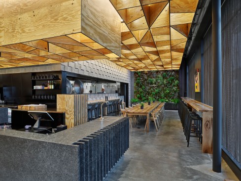 Glowing plywood volume floats above counter