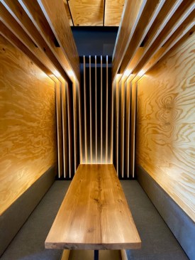 Suspended and surface-mounted Type A lamps at the booths create intimacy.