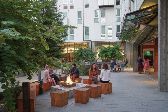855 Brannan, by David Baker Architects, in San Francisco, is a LEED Platinum mixed-use community interweaves high-density homes, open space, and public passages to maximize housing, repair the urban fabric, and activate the edges of an underutilized city block. Shown here, is he Redwood Court Town Hall terrace in the evening.