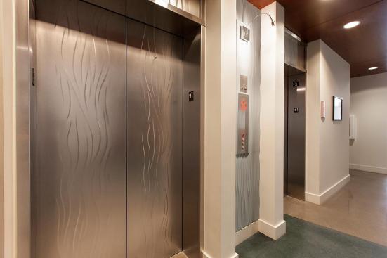 Elevator doors and transoms shown in Stainless Steel with Seastone finish and Campagne pattern at The Matisse, Portland, Oregon