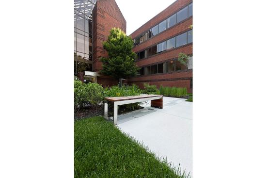 Duo Bench shown with Polished Stainless Steel frame and FSC 100% Jatoba hardwood slats and end at 80 Williams Street, Wellesley, Massachusetts