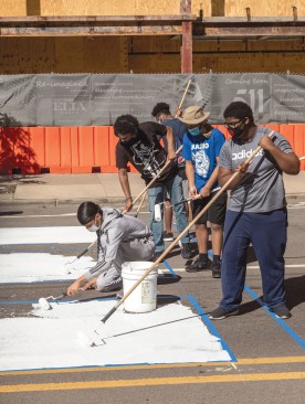 Student artists from Detroit Heals Detroit and Detroit Public Schools Community District paint the Power to the People mural on Woodward Avenue, Detroit.
