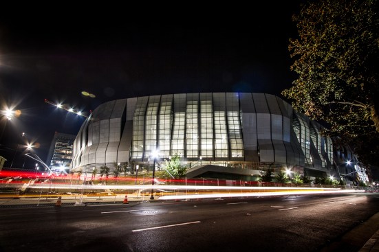 The arena features multiple full-height, glazed entrances.