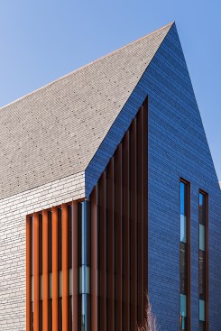 The slate shingles on the roof and wall transition nearly seamlessly.