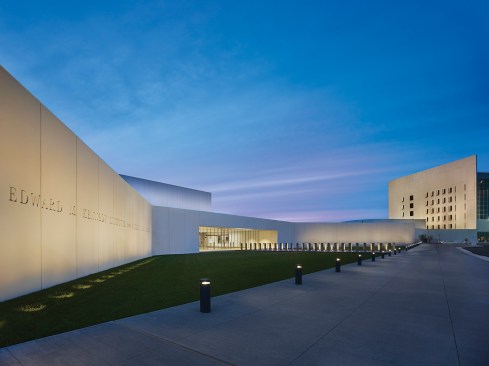At night the building comes alive in a subtle color temperature shift that creates a visual hierarchy of light.
