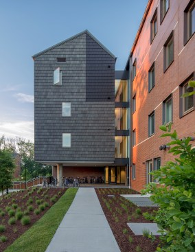 Apartment building entrances include shelter for bicycles