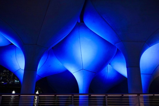 Only the luminaires highlighting the entry pots change color to announce special events; other light sources are kept a warm white to create a serene environment.