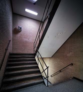 An existing staircase enclosed by the brick core
