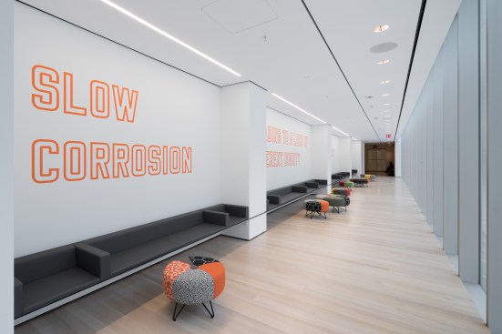 View of The Louise Reinhardt Smith Gallery, including Lawrence Weiner’s Slow Corrosion Leading to a Loss of Inherent Dignity of the Object at Hand (1985)