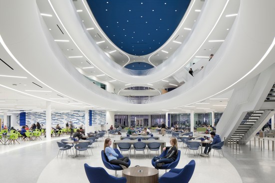 Continuous LED linear fixtures integrated into glass-fiber reinforced ceiling panels create a celestial effect to the dining commons and adjacent lounge spaces.