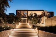 Integrated luminaires bring out the warmth of multi-layered architectural forms, enhancing the processional arrival experience.