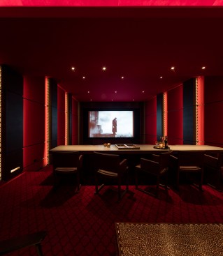 Red cove lighting on the ceiling heightens the immersive “red” experience, offset by white highlights in the reveals.