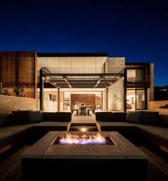 Subtle exterior lighting allows the architectural forms and textures to take center stage as the glowing interiors create a lantern-like effect.