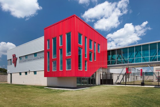 Highline S1 panels are installed vertically in custom reds, and horizontally in Bone White and Cityscape, using varying depths to create additional interest.