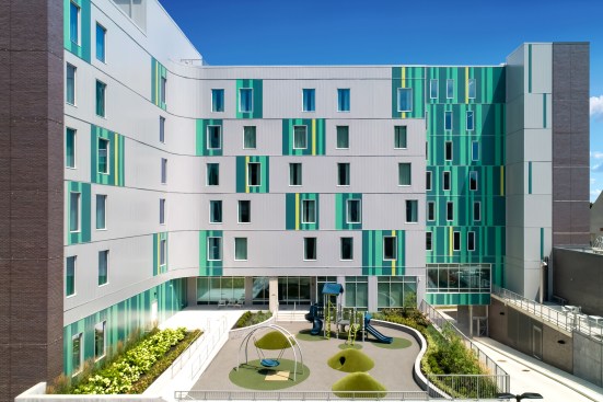 A study in fun, the courtyard of the Cincinnati, Ohio, Ronald McDonald House features metal Flush panels in Patina Green, Teal, and a bright custom Parakeet yellow. The colors reflect the life-affirming elements of the courtyard they surround.