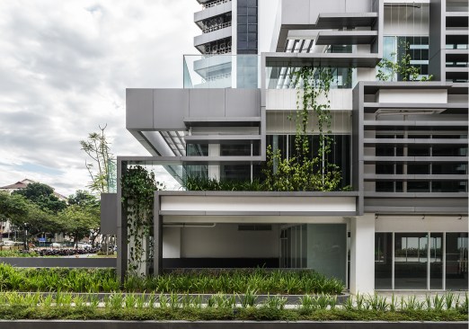 Located in Malaysia, T. R. Hamzah & Yeang’s Plaza Vads features sunshades and vertical green walls that filter the air.