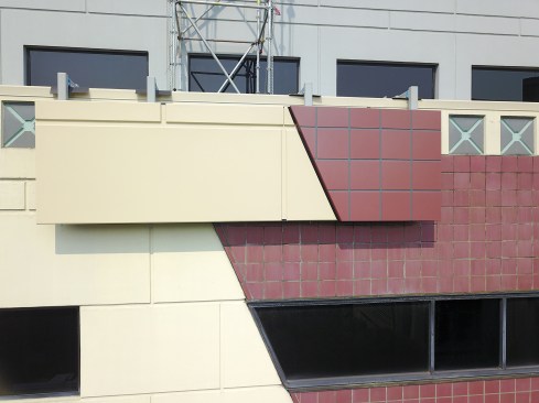 A mock up showing one of the new aluminum panels set against the building's existing façade