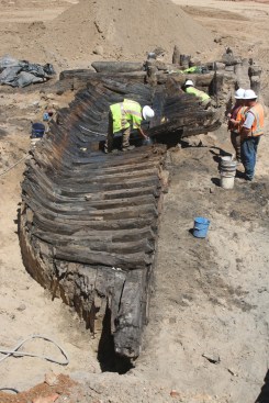 Crews prepare to remove the remnants of an 18th century work ship, known as "Ship Two", from the Robinson Landing site. The ship was likely buried before 1798 as fill for new waterfront land.