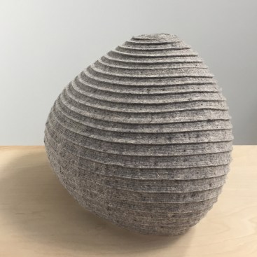 Felted poof with a complex geometric surface