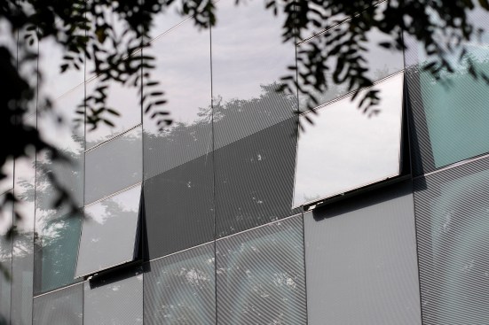 The frit patterns vary in density on the glazed curtain wall and spandrel panels.
