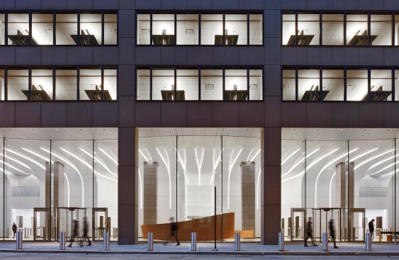 Exterior views of the lobby show the lighting coves continuing from the walls to the ceiling while widening upward to the glass façade.