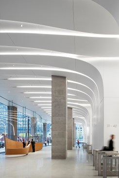The lobby features complex ceramic ceiling and walls, expressing the transition into the elevator lobbies where it changes to a wall-grazing detail.