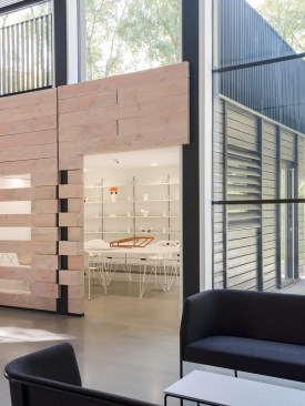 The Douglas fir wall screens off a more private model-building space.