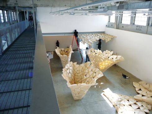 Students helped to construct the individual petals and then the actual structure. A team of students is seen working to install some of the perimeter petal sections.