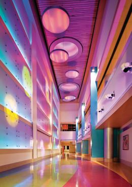 Pops of color provide visual relief throughout the facility, including the connecting corridor between the new tower and existing facilities.
