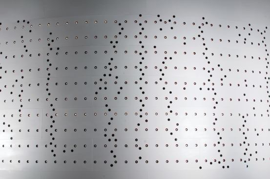 One worker with a flame-cutter made each of the 2,012 holes, which are 150 millimeters (5.9 inches) in diameter.