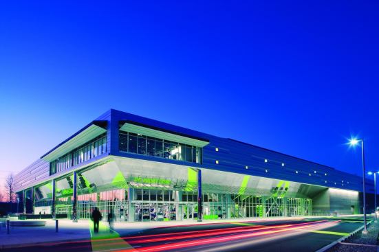 LMN Architects took cues from its experience in theater design when programming the center, using lighting and supergraphics to choreograph the visitors' experience from the highway approach all the way through to reaching their seat for the game.