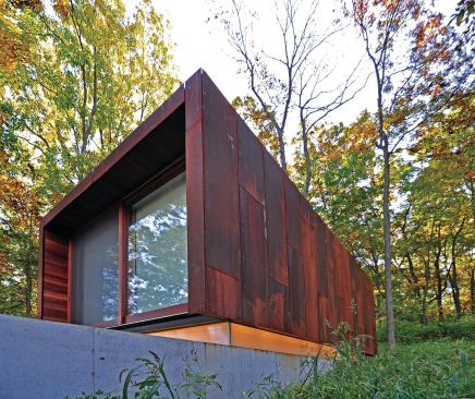 Studio for a Composer floats a steel-clad volume over a half-buried concrete base.